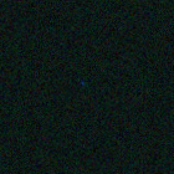 A matching blue cosmic-ray mark mid-frame, far from the annotated corner.