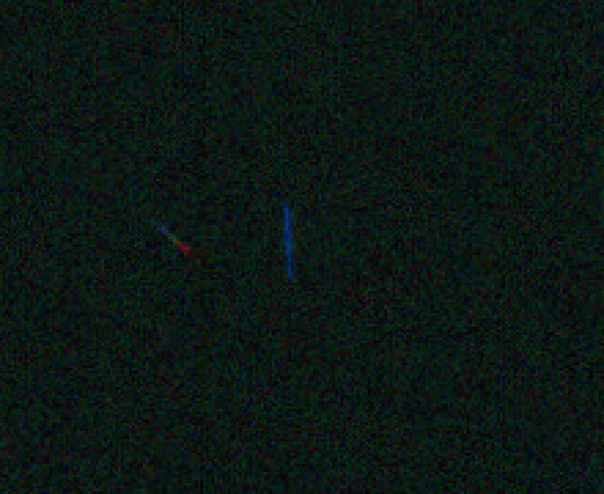Original NASA scan crop: a vertical blue streak and a diagonal blue-to-red streak against the sky.